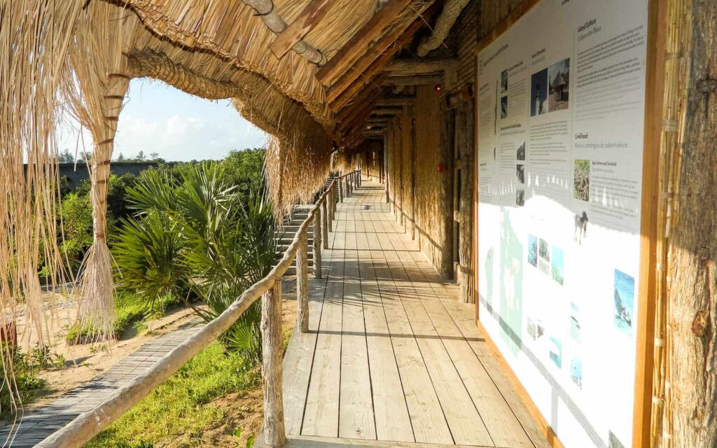 Hallway in a safari property made out of bamboo, with an information tarpaulin hanging on the wall