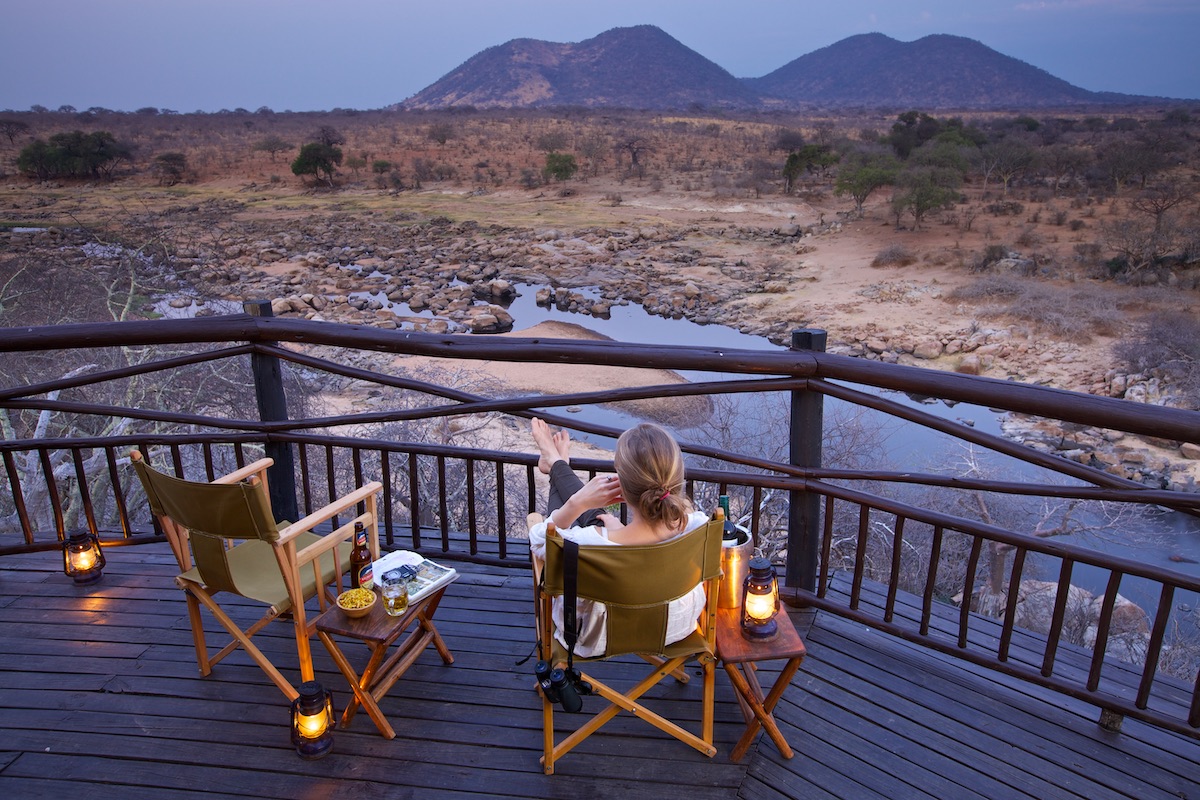 a woman relaxing on a porch on a safari