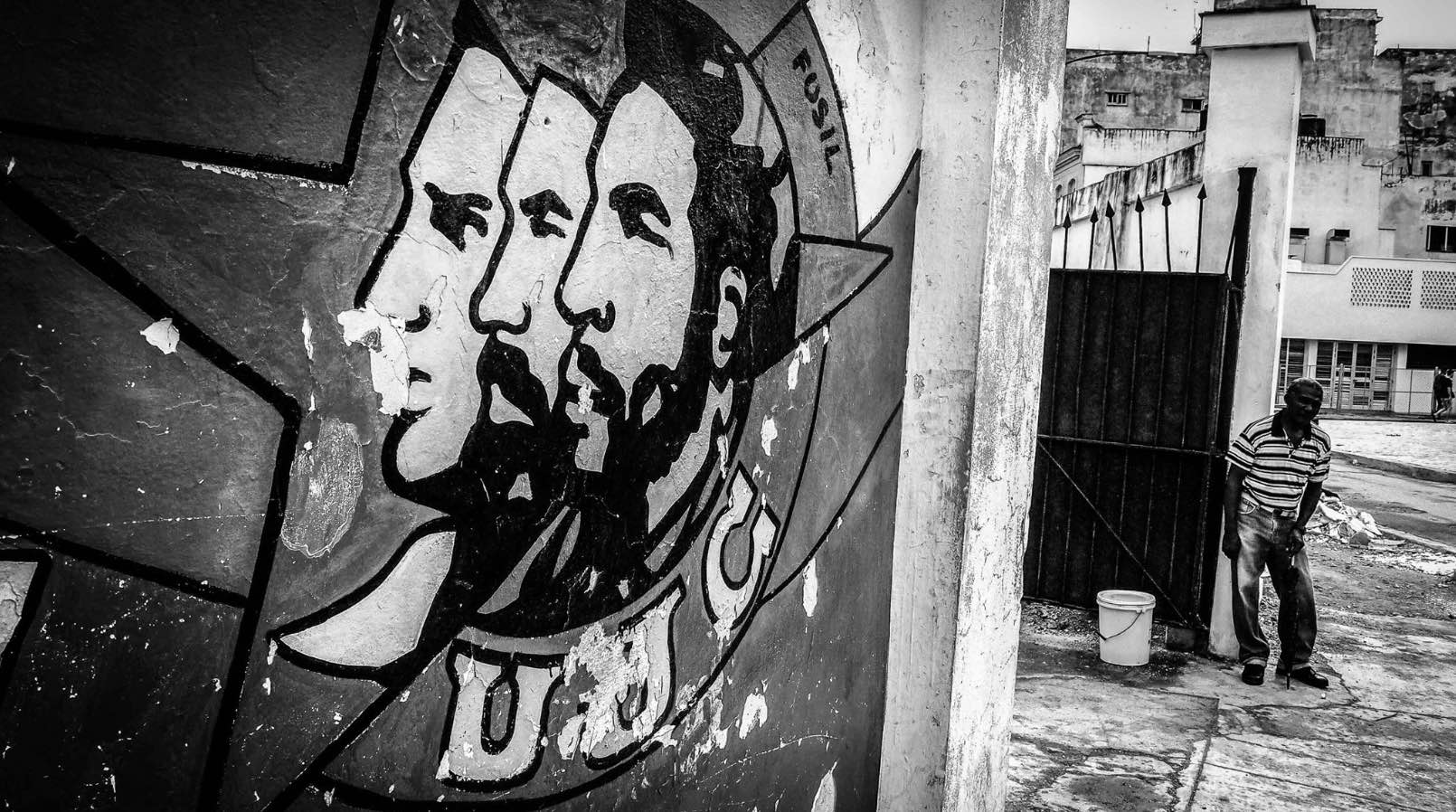 a mural painting of 3 men in Cuba
