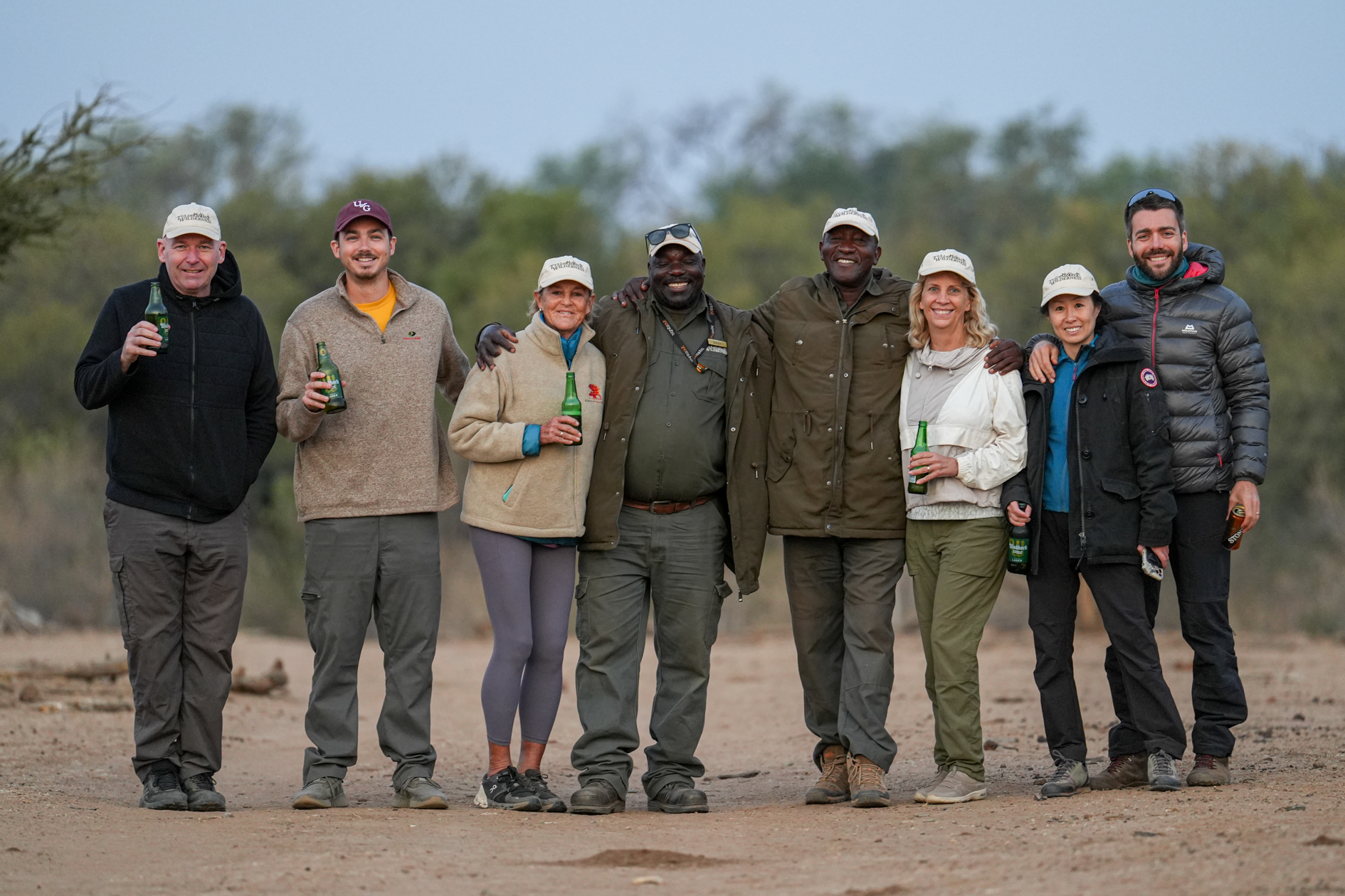 A diverse group of people standing together and enjoying each other's company.