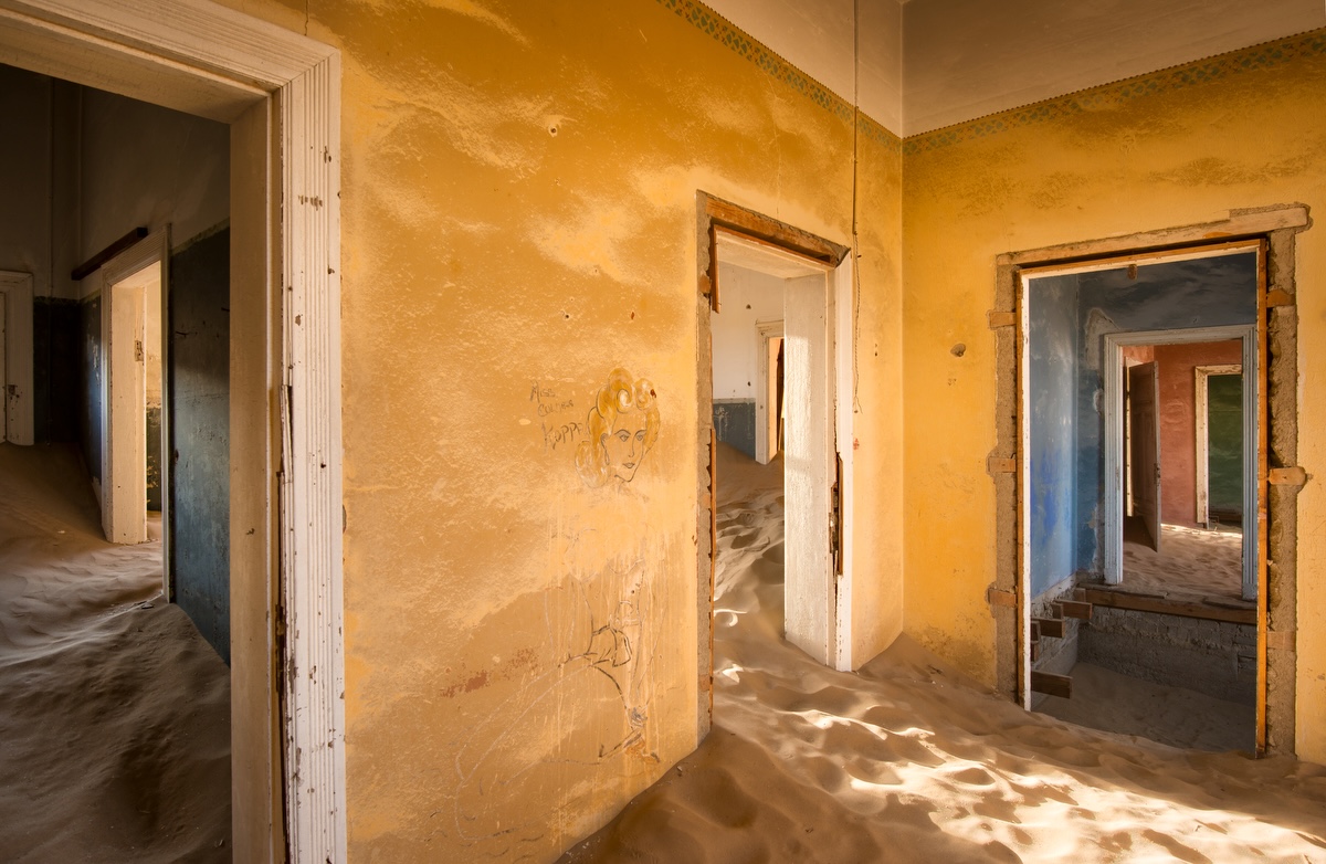 Sand-filled rooms inside a crumbling house